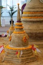 Close up a sand pagoda surrounded with yellow flowers on sand floor