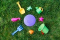 close up of sand toys kit on green lawn or grass