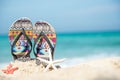 Close up sandals on the sand beach with starfish sandy beach. Royalty Free Stock Photo