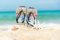 Close up sandals on the sand beach with starfish sandy beach. Royalty Free Stock Photo