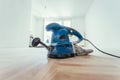 Renovating at home: sander tool for refreshing and grinding the wooden parquet floor