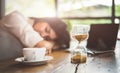 Close up of sandglass with business woman tired from working wit Royalty Free Stock Photo