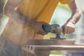 Close up of sanding a wood with orbital sander at workshop electric sander carpenter refining the surface Royalty Free Stock Photo