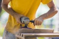 Close up of sanding a wood with orbital sander at workshop electric sander carpenter refining the surface Royalty Free Stock Photo