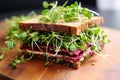 close up of a sandwich filled with vibrant microgreens