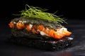 close-up of sandwich made from black squid ink bread and prawns