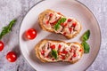 Close up of sandwiches with canned tuna, pepper and basil on cream cheese on a plate top view Royalty Free Stock Photo