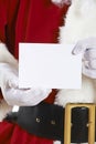 Close Up Of Santa Claus Holding Blank Invitation Royalty Free Stock Photo