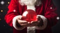 Close-up of Santa Claus hands holding a crystal ball on dark background