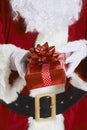 Close Up Of Santa Claus Holding Gift Wrapped Present Royalty Free Stock Photo