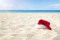 Close up Santa hat on a white sandy infinity caribbean beach . Christmas Holiday Travel Concept Royalty Free Stock Photo