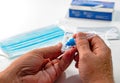 Close up SARS Cov 2 coronavirus rapid antigen test nasal kit. A man doing Covid-19 Self test at home. Hand holding test on white b Royalty Free Stock Photo