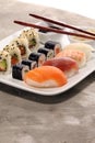 Close up of sashimi sushi set with chopsticks and soy - sushi roll with salmon and sushi roll with smoked eel Royalty Free Stock Photo