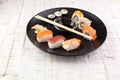 Close up of sashimi sushi set with chopsticks and soy - sushi roll with salmon and sushi roll with smoked eel, selective focus. Royalty Free Stock Photo
