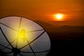 Close up, satellite dish communication technology network for a village in the countryside. Sky gold and sunset on the valley Royalty Free Stock Photo