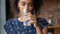 Close up satisfied African American woman drinking pure mineral water Royalty Free Stock Photo