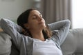 Close up satisfied attractive woman resting on couch alone