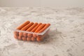 Close-up of sausages. Sausages in plastic and place for text. Boiled raw bavarian sausages and copy space Royalty Free Stock Photo