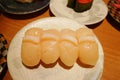 Close up of scallop hotate sushi nigiri on plate in sushi belt japanese restaurant