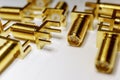 Close-up of scattered gold plated SMA male connectors electronics components in partial focus on white background in random patter Royalty Free Stock Photo