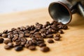 Close-up of a scattering of coffee beans on a wooden board