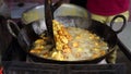 A close-up scene of frying crispy tikadi called flitter and pakoda Indian street food, onion pakora specially for rainy season