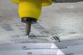 Close-up scene of multi-axis abrasive waterjet cutting machine cutting the aluminum plate