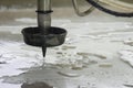 Close-up scene of multi-axis abrasive waterjet cutting machine cutting the aluminum plate