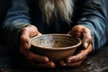 Close up scene old mans hands, empty bowl, symbolizing the depth of hunger