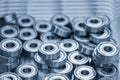 Close up scene the pile of cylindrical ball bearing parts in the light blue scene Royalty Free Stock Photo