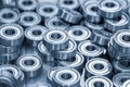 Close up scene the pile of cylindrical ball bearing parts in the light blue scene Royalty Free Stock Photo