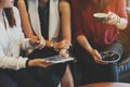 Close up scene of 3 woman using tablet together in coffee shop