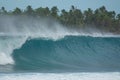 CLOSE UP: Scenic shot of a big barrel wave rolling to a beautiful exotic beach. Royalty Free Stock Photo