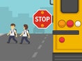 Close-up of school bus with an extended stop sign. School boys crossing the street. Royalty Free Stock Photo