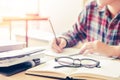 Close- up.School student holding pencil taking exams writing in classroom for education concept Royalty Free Stock Photo