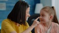 Close up of schoolgirl and mother doing homework together