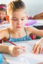 Close-up of schoolkid doing homework in classroom