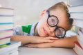 Close-up of schoolkid leaning on desk in classroom