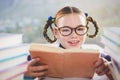 Close-up of schoolkid reading book in classroom