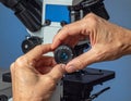 Close-up of Scientist Adjusting Microscope for Laboratory Research Royalty Free Stock Photo
