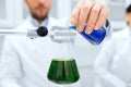 Close up of scientist filling test tubes in lab Royalty Free Stock Photo