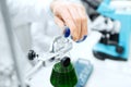 Close up of scientist filling test tubes in lab Royalty Free Stock Photo