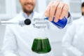 Close up of scientist filling test tubes in lab Royalty Free Stock Photo