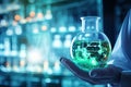 Close up of scientist hand holding flask with green glowing network hologram, hand of scientist holding flask with lab glassware