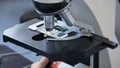 close-up of scientist hands with microscope, examining samples and liquid. microscope Royalty Free Stock Photo