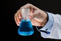 Close up of scientist holding flask with chemical Royalty Free Stock Photo