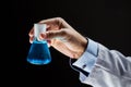 Close up of scientist holding flask with chemical Royalty Free Stock Photo