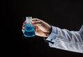 Close up of scientist holding flask with chemical Royalty Free Stock Photo