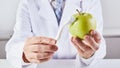 Scientist cleaning green apple with toothbrush