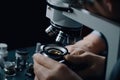 close up of scientist looking through microscope in laboratory, science research concept,Doctor using a microscope with a metal